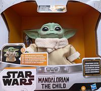 Front of sealed retail box showing animatronic Baby Yoda figure and branding
