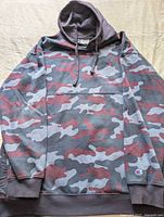 Front view of Champion camo hoodie showing pattern, pocket and hood