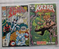 Front covers of Silver Surfer and Ka-Zar comics in protective bags