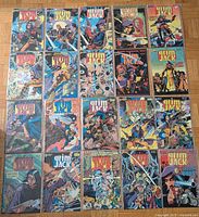 Top-down photo showing all twenty GrimJack comic books arranged in four rows
