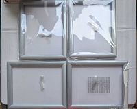 Four individually wrapped silver frames