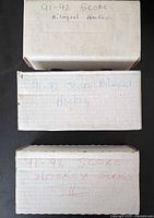 Three labelled card boxes on black background