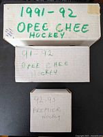 Three labeled card storage boxes on tabletop