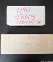 Shows two cardboard boxes labeled 1990 Topps Hockey and 1991 Topps Hockey