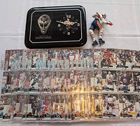 Overall lot showing clock, Gretzky figurine, and pages of hockey cards