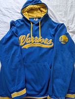 Front view showing logo, pocket and yellow accents