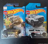 Front view of both Hot Wheels blister packs showing vehicles and card art