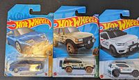 Front view of all three Hot Wheels cars in original packaging