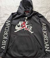 Front view showing graphic, pouch pocket, sleeve prints