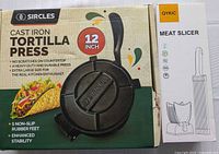 Retail boxes of Sircles cast iron tortilla press and OYKIC meat slicer