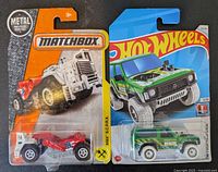 Sealed Matchbox MBX S.C.R.P.X truck and Hot Wheels Land Rover Defender 90 SUV in original blister packaging