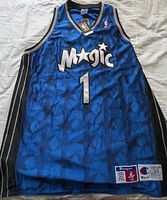 Full front view of blue Orlando Magic #1 Champion jersey