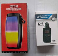 Front view of boxed ZQS1202 wireless speaker and boxed FM car transmitter