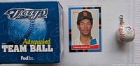 Front of lot showing Jays Autographed Team Ball box, Roberto Alomar rookie card, and mini Blue Jays baseball keychain