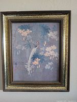 Full view of framed painting with bird and flowers