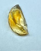 Oblique view of golden faceted citrine half-stone