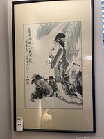 Full view of framed Asian silk painting on wall