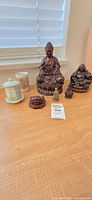 Group of seven Buddhist-themed items on table