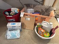 Group shot of bathroom scale, laundry basket, buckets, cleaning supplies and masks