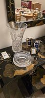 Crystal vase, bowl, three picture frames displayed on table