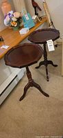 Both matching mahogany pedestal side tables front view