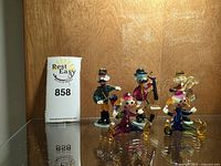 Front view of all six miniature glass figurines