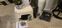 Group shot showing stool, planter, pitcher, clock, vase, phone set, Miracle-Gro boxes