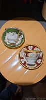 Two teacup and saucer sets on tabletop