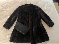 Coat front view with stingray purse displayed across front