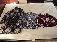 Overall view of all garments and purse on bed