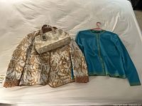 Group view of jacket, purse, sweater