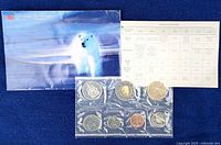 Front view showing envelope, specification card, sealed coin set