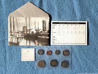 Complete set with envelope, spec card, gift tag and 7 coins