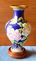 Full view of cloisonné vase on wooden stand