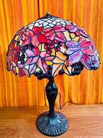 Full view of Tiffany-style lamp showing stained glass shade and metal base