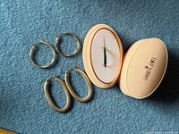 Overview of both earring pairs, eternity ring in case