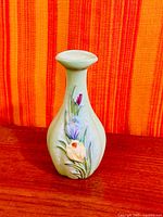 Front view showing floral relief decoration on green Beswick bud vase