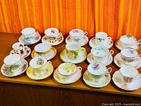 All teacups and saucers arranged on cabinet