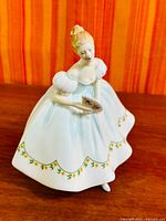 Front view of Royal Doulton First Dance figurine showing dress and fan