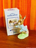 Front view of Royal Albert Peter Rabbit figurine standing beside original box