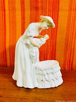 Front view of Royal Doulton Mother and Son figurine showing mother, infant, and bassinet
