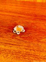 Top view of small faceted crystal turtle on wooden surface