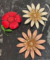 Front view of all three floral brooches