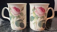 Front view of both mugs showing rose pattern