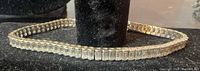 Full view of sterling silver tennis bracelet with baguette CZs displayed in oval shape