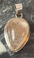Front view of teardrop rutilated quartz pendant with bail