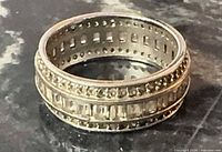 Full view of sterling silver multi-row ring standing upright