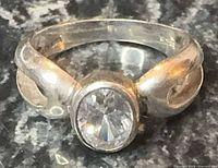 Front view of sterling silver ring with round clear CZ stone