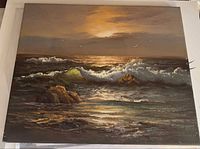 Front view of entire seascape painting showing waves, rocks, sunset