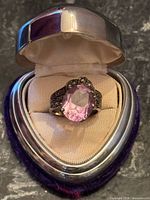 Ring in presentation box showing overall design and center stone